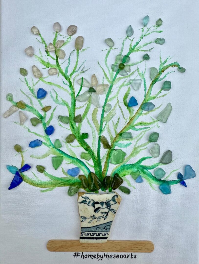 Mixed media artwork of flowers made with real shells and watercolour greenery in a blue-and-white sea pottery vase, on a 24x18cm canvas.