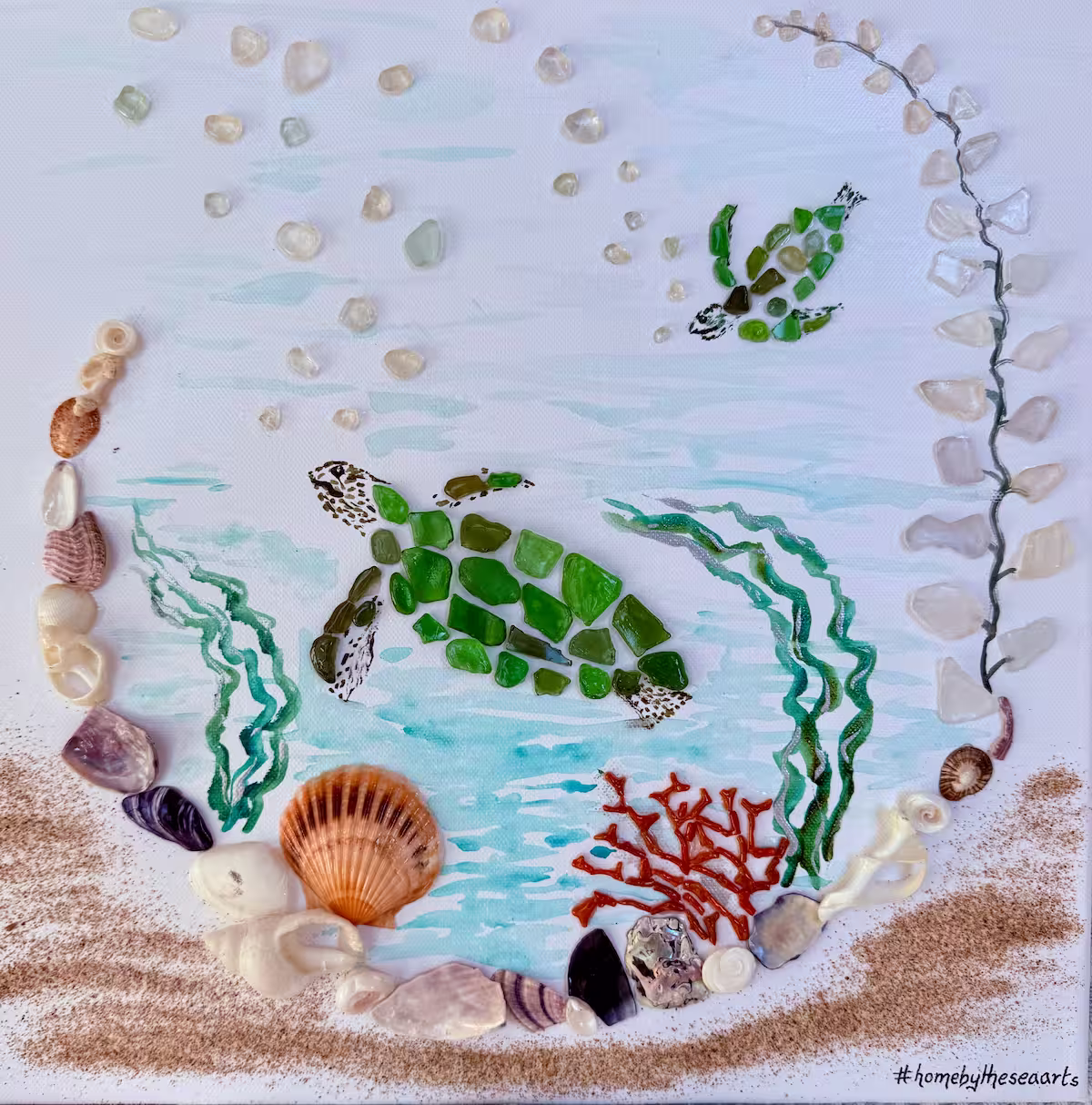 Underwater-themed artwork with turtles, coral, and seaweed made from sea glass, sand, and shells on a 40x40cm canvas.